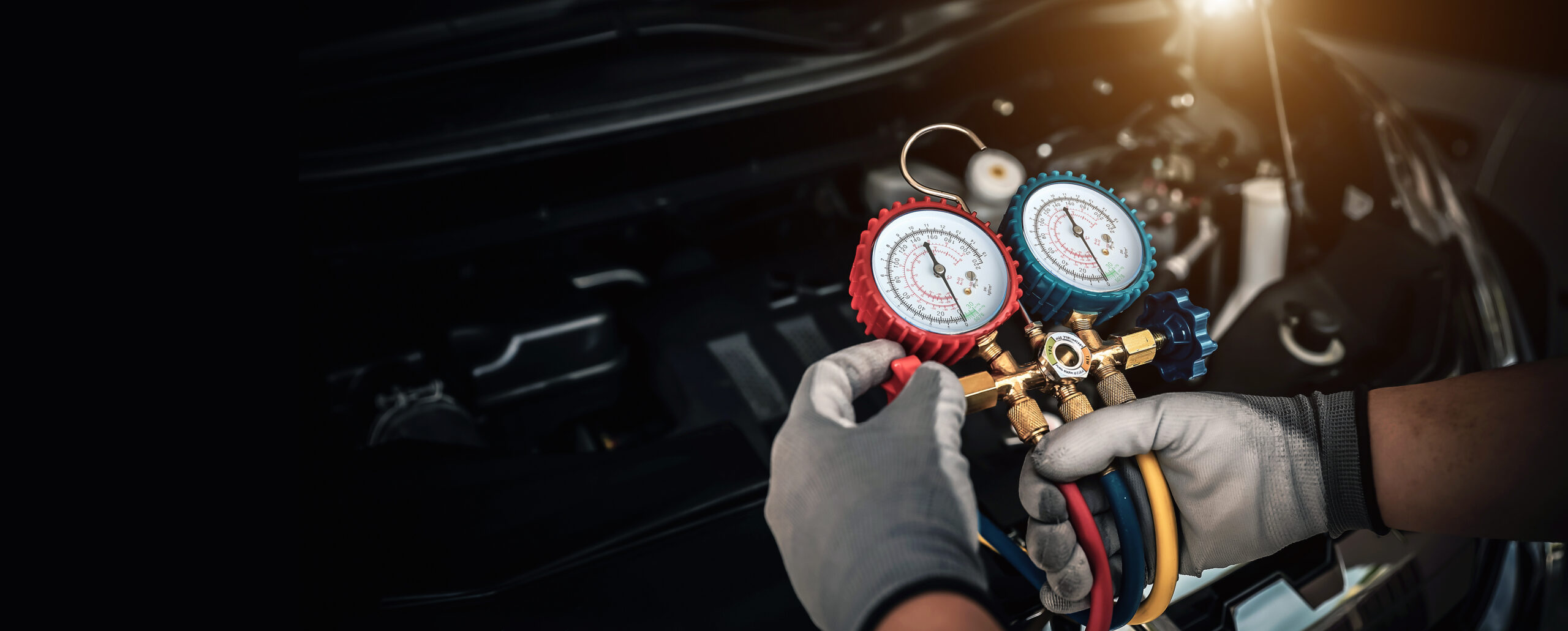 Hand of car mechanic technician use meter to check car air condi